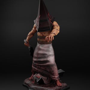 May include: A detailed figurine of a character with a large, dark pyramid-shaped head. The figure has a muscular torso, wrapped in barbed wire, and wears a blood-stained apron. It holds a large blade and stands on a textured base.