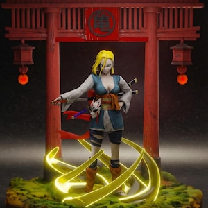 May include: A figurine of a female character with blonde hair, wearing a blue and white outfit, and holding a sword. The figure stands in front of a red Japanese torii gate. The base is green with yellow energy effects.