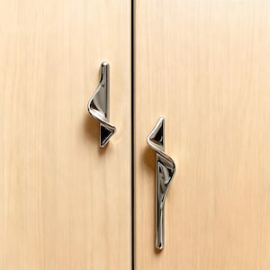 May include: A white ceramic mug with a black handle and the text "But First, Coffee" in a black, bold font. The mug is on a white surface.