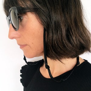 black faux leather face mask and eyeglass lanyard