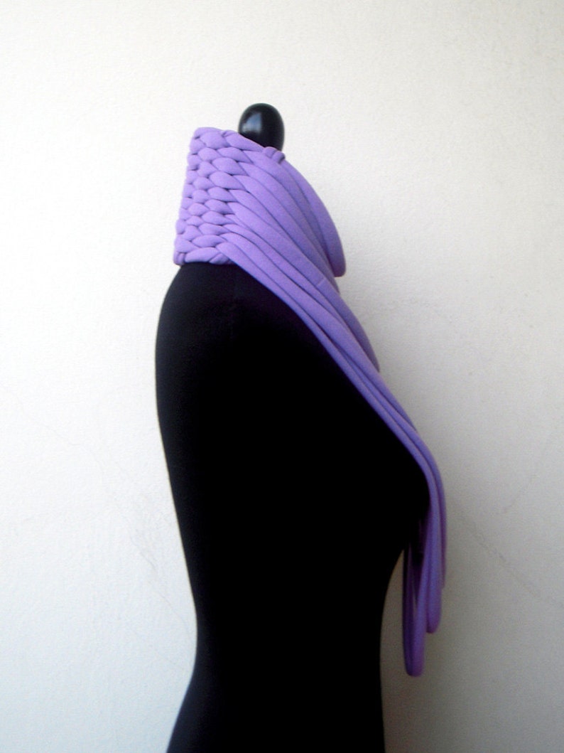May include: A purple knitted cowl neck scarf on a black mannequin.
