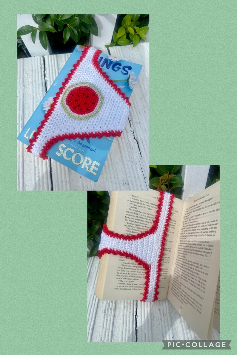 May include: A white crocheted bookmark with a red scalloped edge and a central red circle featuring black seed-like details. The bookmark is shown resting on a blue book cover titled Score and inside an open book with printed text pages.