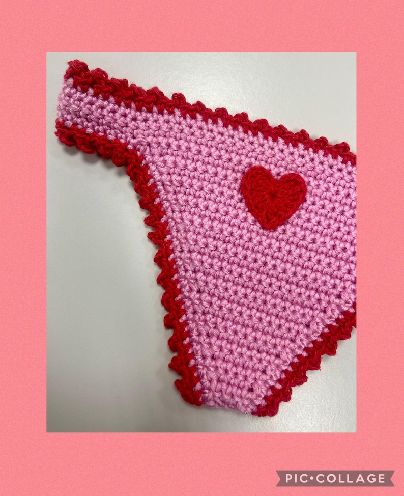 May include: A light pink crochet bikini bottom featuring a vibrant red heart appliqu&eacute; centered on the front. The edges of the garment are finished with a decorative red scalloped crochet trim. The text PIC COLLAGE is visible in the bottom corner.