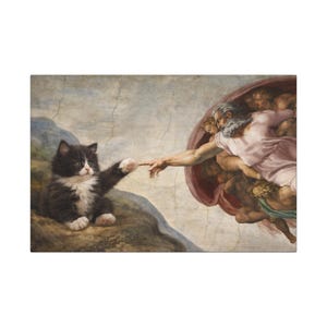 May include: A comical print depicting a black and white kitten in a parody of Michelangelo's 'The Creation of Adam'. The kitten's paw touches God's finger, set against a light blue and beige backdrop.