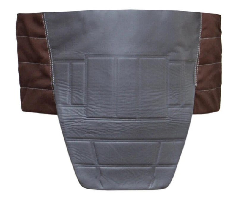 May include: A gray and brown seat cover with a quilted design. The center section is gray with horizontal and vertical stitched lines. The sides are brown with horizontal stitching and white thread.
