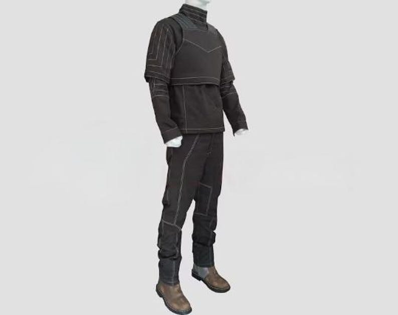 May include: A black tactical outfit displayed on a mannequin. The outfit includes a high-collared jacket, a vest, and pants, all with white stitching. The boots are brown and gray.