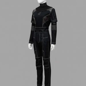 May include: A black two-piece outfit consisting of a short-sleeved top with a high mock neck and long trousers. The ensemble features prominent white contrast stitching, geometric paneling, and intricate grid-patterned details on the sleeves.