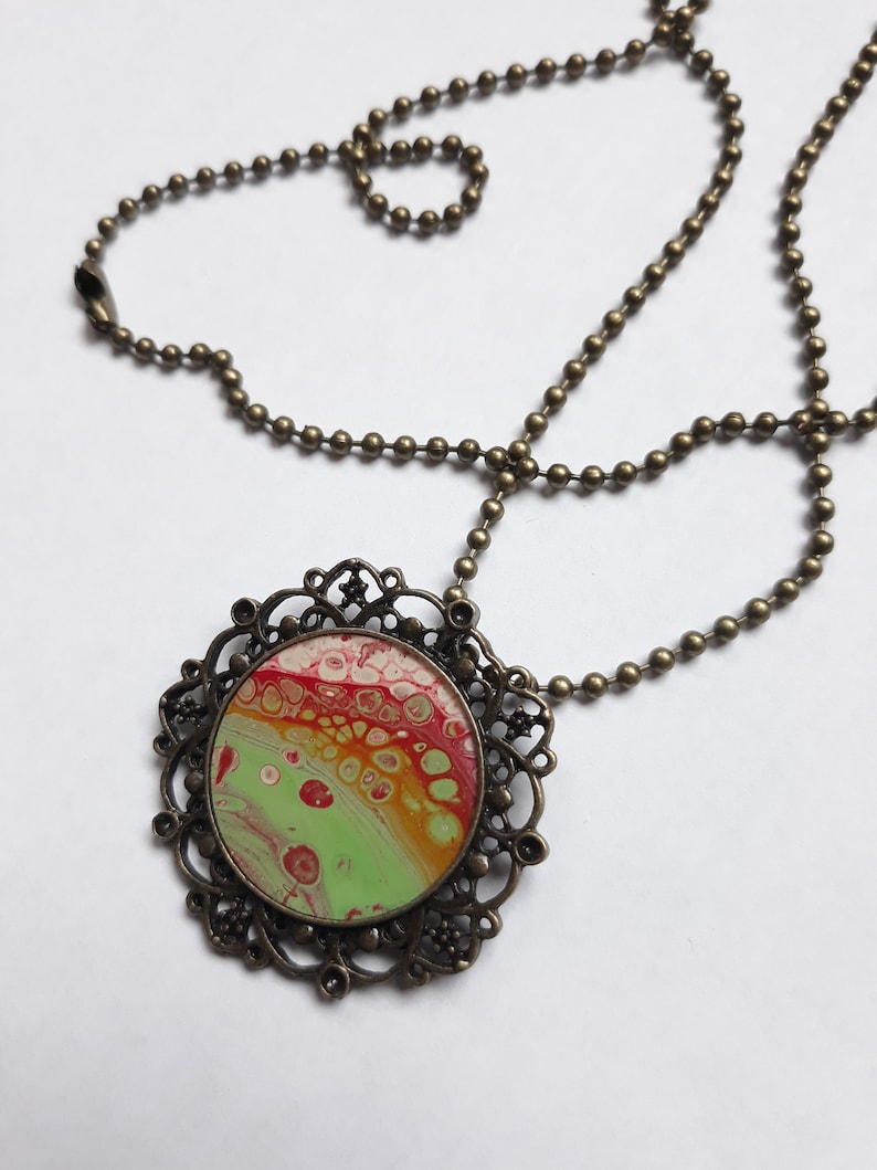 Pendant necklace with fluid paint design