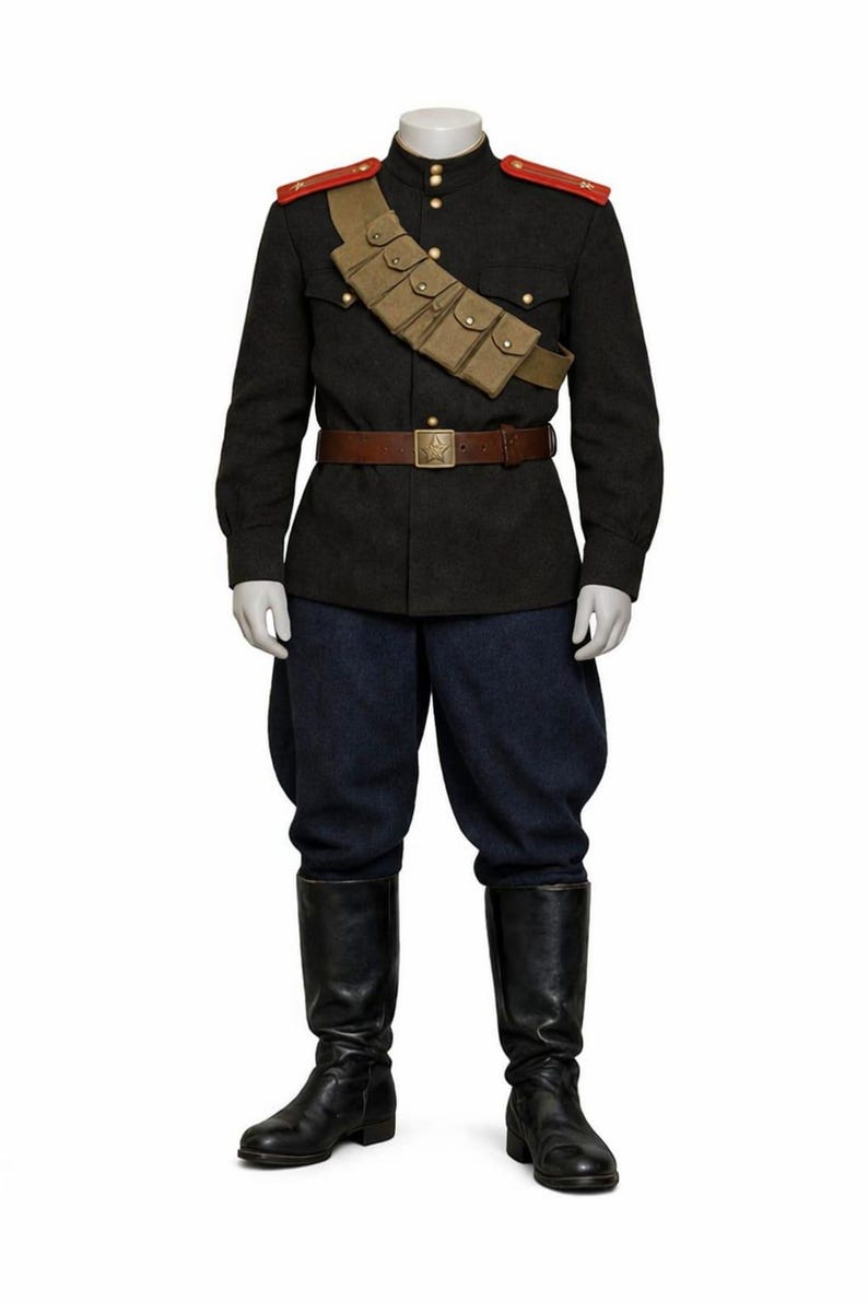 May include: A military uniform on a mannequin. The dark gray jacket has gold buttons, red shoulder boards, and a tan cartridge belt. The uniform includes navy blue pants, a brown belt, and black leather boots.