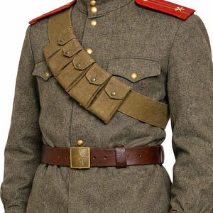 May include: A vintage military uniform in olive green, featuring a brown leather belt with a star-shaped buckle. The uniform includes a shoulder strap with pouches and red shoulder boards with star emblems. The jacket has gold buttons.