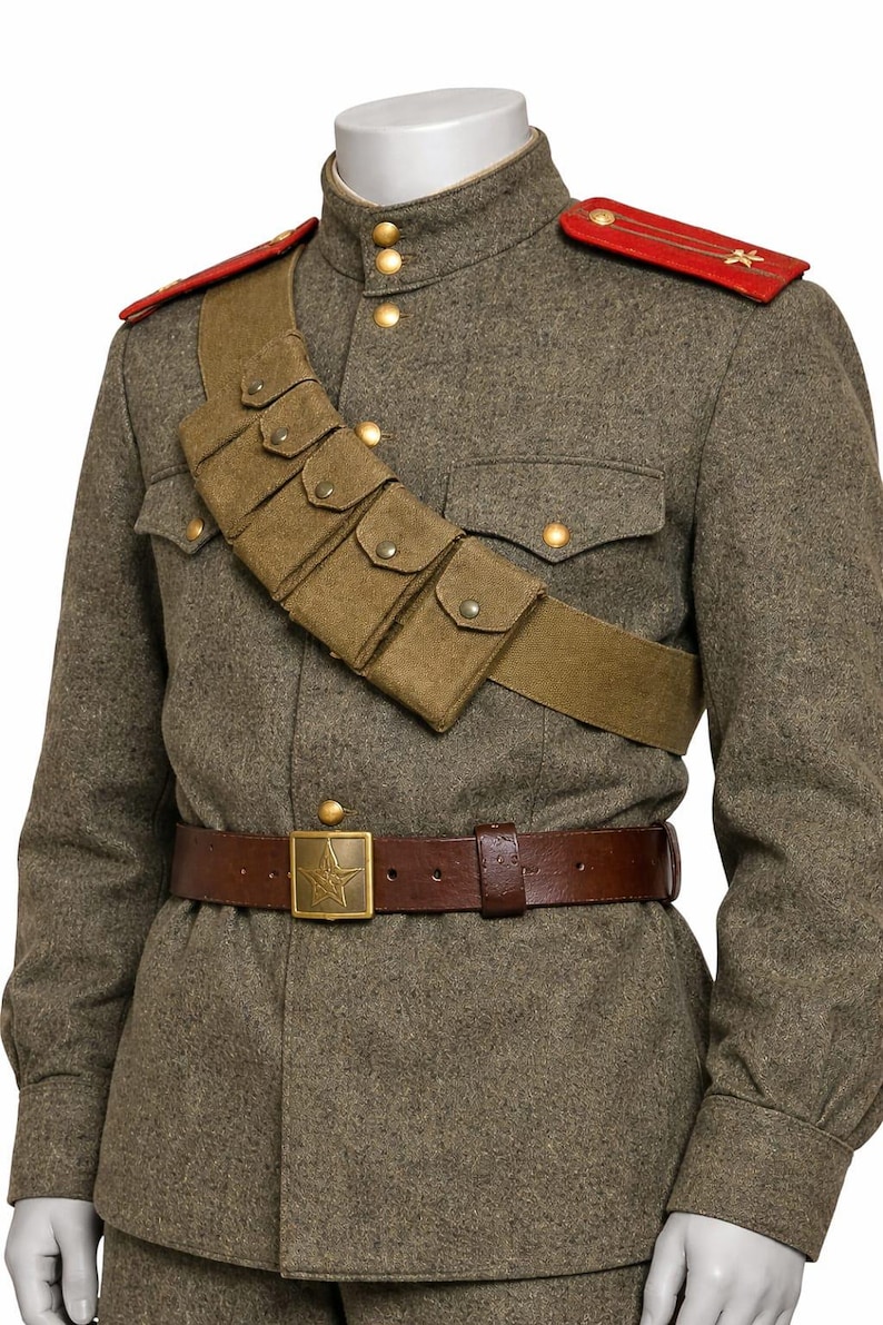 May include: A vintage military uniform in olive green, featuring a brown leather belt with a star-shaped buckle. The uniform includes a shoulder strap with pouches and red shoulder boards with star emblems. The jacket has gold buttons.