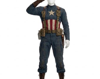 May include: A full-body shot of a mannequin wearing a Captain America costume. The costume includes a blue long-sleeved shirt with a white star, a red and white striped chest, and blue pants. Brown boots, a utility belt, and a brown leather glove complete the look.