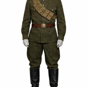 May include: A military uniform in olive green, featuring a button-down jacket, matching trousers, and tall black boots. The uniform includes a brown leather belt, a cartridge belt, and red shoulder boards. The mannequin is on a white background.
