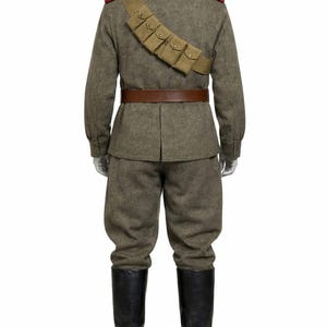 May include: A military uniform on a mannequin. The olive-drab wool uniform includes a jacket with red shoulder boards, matching trousers, a brown leather belt, and black leather boots. A bandolier with pouches is across the chest.