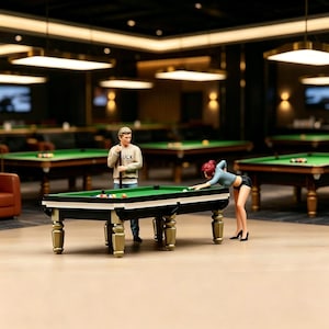 May include: Miniature scene of a pool hall with two figures playing billiards. The pool table is green with black trim and gold legs. One figure is holding a pool cue, while the other is leaning over the table. The background shows other pool tables and a bar setting.