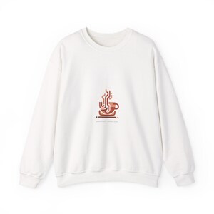 May include: White crew neck sweatshirt with a brown coffee cup graphic and the text "Jesus First - Coffee Later". The graphic features a stylized coffee cup with steam rising from it.