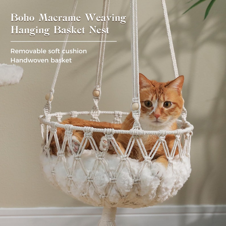 May include: A handwoven macrame hanging basket nest featuring off-white cotton cord, wooden beads, and a removable soft white cushion. An orange tabby cat rests inside the basket. Text on the image reads: Boho Macrame Weaving Hanging Basket Nest.