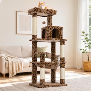 May include: A multi-level cat tree featuring a leopard print fabric covering, multiple platforms, a central enclosed cubby, a hanging toy ball, and several vertical scratching posts wrapped in light-colored sisal rope, with two cats resting on it.