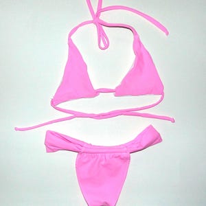 May include: A set of three ceramic mugs with a speckled, matte finish. Each mug features a different color: light blue, cream, and gray. The mugs have a simple, modern design and a comfortable handle.