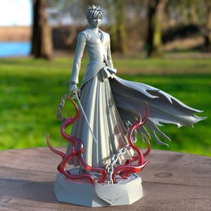 May include: A detailed figurine of a character in a long coat and flowing skirt, holding a sword. The figure is primarily gray, with red accents at the base. The figure is standing on a gray base with red, vine-like details.