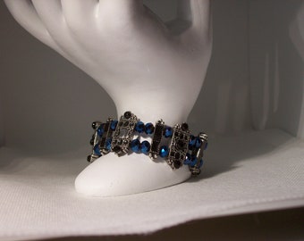 Stretch Bracelet-midnight blue, 6 mm oval crystals with black and gun metal beaded spacer beads.  8 inches but one size fits all.