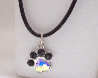 Dog paw crystal pendant necklace 17 inch black velvet chain.  size of a dime,  center crystal is heart shape upside down,  Dog paws are 6 MM