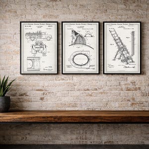 May include: Three framed vintage patent prints of firefighting equipment hang on a brick wall above a wooden bench. The prints depict a fire truck, a fire helmet, and a ladder. A potted plant sits on the bench.