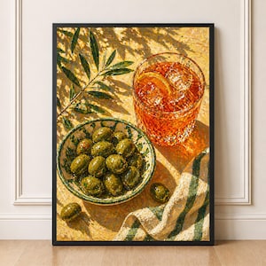 May include: A framed still life painting depicting a bowl of green olives, a glass of amber cocktail with ice and an orange slice, and a green and white striped cloth. An olive branch is visible in the upper left corner. The painting has a warm colour palette.