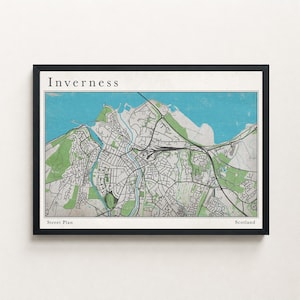 Può includere: Una mappa stradale incorniciata di Inverness, Scozia. La mappa presenta una planimetria dettagliata della città con strade, edifici e spazi verdi. Il titolo "Inverness" è in alto, con "Street Plan" e "Scotland" in basso. La mappa è nei toni del verde, blu e bianco.