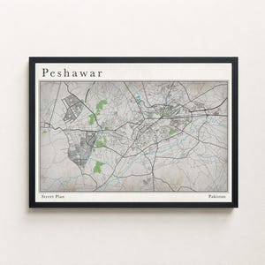 May include: A framed street plan map of Peshawar, Pakistan. The map is in monochrome with green shaded areas. The word "Peshawar" is at the top, and "Street Plan" and "Pakistan" are at the bottom.