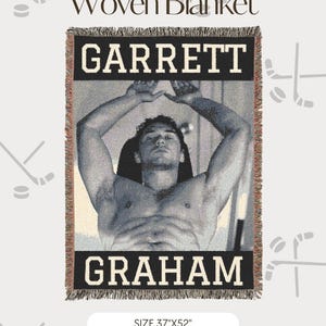 May include: A woven blanket featuring a black and white photographic print of a person with arms raised above their head. The text GARRETT appears at the top and GRAHAM at the bottom in bold lettering. The blanket measures 37 inches by 52 inches.