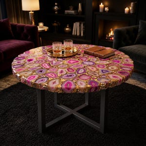 Luxury pink agate round coffee table with black metal base in modern living room
Handmade gemstone coffee table with glossy agate stone top and designer metal stand
