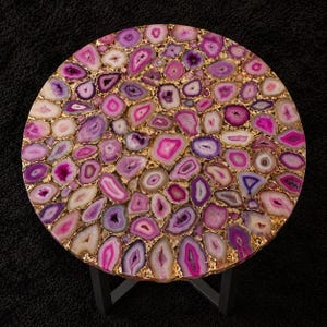 Contemporary round agate center table with pink crystal texture and luxury decor
Modern black metal coffee table featuring natural agate stone mosaic tabletop