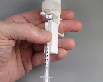 Adjustable syringe guide and vial holder with user-friendly finger handle