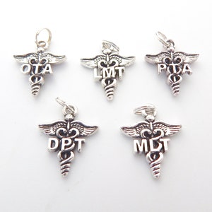 May include: Five silver medical caduceus charms with different abbreviations: OTA, LMT, PTA, DPT, and MLT.