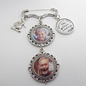 May include: Silver charm bracelet with two photo frames and a graduation cap charm. The charm has the text "I know you'd be with me today if heaven weren't so far away".