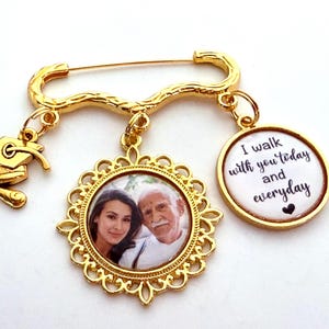 May include: Gold-toned brooch with a photo charm, a graduation cap charm, and a charm with the text "I walk with you today and everyday".