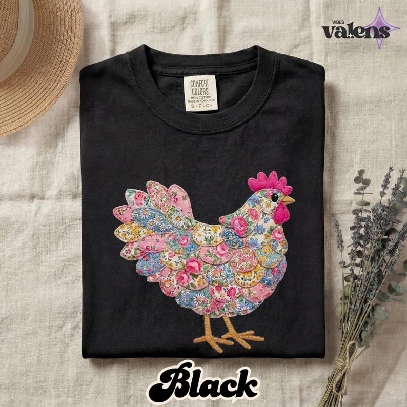 May include: Black t-shirt featuring a colorful chicken design. The chicken is made of fabric with floral patterns in pink, blue, and yellow. The word "Black" is written in a cursive font at the bottom of the shirt.