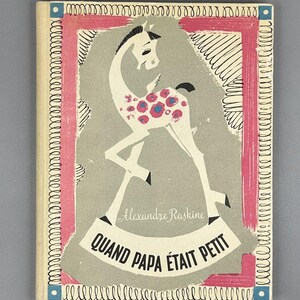 May include: Vintage children's book cover featuring a stylized giraffe with pink and blue floral spots. The cover has a pink and blue border, with the title "QUAND PAPA ÉTAIT PETIT" and the author's name, Alexandre Raskine.