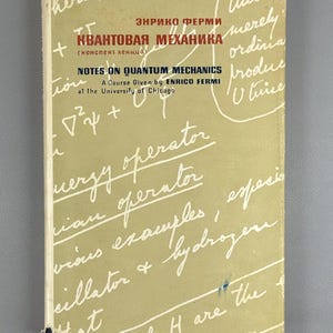 May include: A vintage book titled "Notes on Quantum Mechanics" by Enrico Fermi. The cover is a faded beige with handwritten notes and equations in white. The title is in both English and Russian.