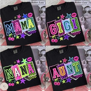 May include: Black t-shirts with colorful graphic designs. Each shirt features a different word: "MAMA", "GIGI", "NANA", and "AUNT". The designs include neon lettering, stars, lips, cherries, and animal print patterns.