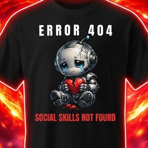 Könnte beinhalten: Schwarzes T-Shirt mit einem traurigen Roboter, der ein zerbrochenes Herz hält. Der Text "ERROR 404" steht über dem Roboter, und "SOCIAL SKILLS NOT FOUND" darunter. Das Design ist vor einem feurigen, herzförmigen Hintergrund platziert.