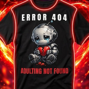 Könnte beinhalten: Schwarzes T-Shirt mit dem Text "ERROR 404" und "ADULTING NOT FOUND". Das Shirt zeigt einen Cartoon-Roboter, der ein zerbrochenes Herz hält. Das Design ist rot umrandet und vor einem feurigen Hintergrund platziert.