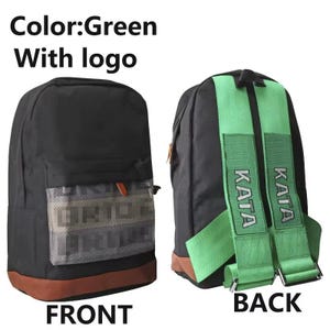 May include: Black backpack with green straps and a brown bottom. The front has a mesh pocket with a logo. The straps have the word "KATA" printed on them. The text "FRONT" and "BACK" are also visible.