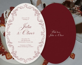 May include: Wedding invitation with an oval shape, featuring burgundy text and decorative border. The invitation reads "Julia & Oliver" and includes event details. A second burgundy card is visible.