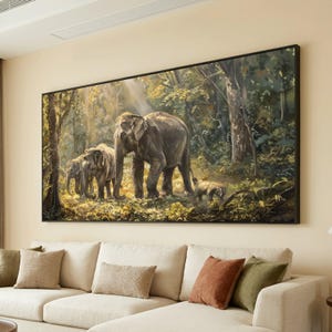 May include: A large framed painting depicts a family of elephants in a lush forest. The artwork features a herd of gray elephants, including adults and calves, amidst dense green foliage. Sunlight streams through the trees, illuminating the scene.