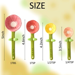 May include: A set of four flower-shaped measuring spoons. The spoons are in shades of pink, red, and yellow, with green stems and leaf accents. Sizes range from 1/4 tsp to 1 Tbsp, with the largest spoon measuring 5 inches.