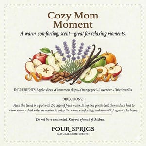 May include: An illustration featuring apple slices, cinnamon chips, orange peel, lavender, and dried vanilla. The text reads "Cozy Mom Moment" and describes a warm, comforting scent. Instructions are provided for use, along with the brand name "FOUR SPRIGS."