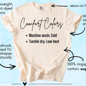 May include: A cream-colored short-sleeve t-shirt with text reading Comfort Colors, Machine wash: Cold, and Tumble dry: Low heat. Annotations highlight features including mediumweight garment-dyed fabric, a sewn-in tag, double-needle stitching, preshrunk relaxed fit, and 100% ringspun cotton.