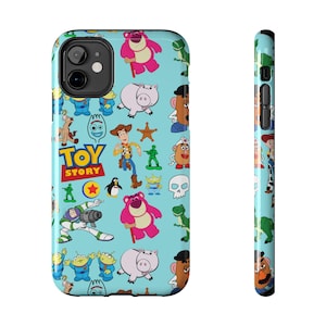 May include: A light blue phone case featuring a pattern of Toy Story characters. The design includes Woody, Buzz Lightyear, Mr. Potato Head, and other characters from the animated film. The case also has the Toy Story logo.